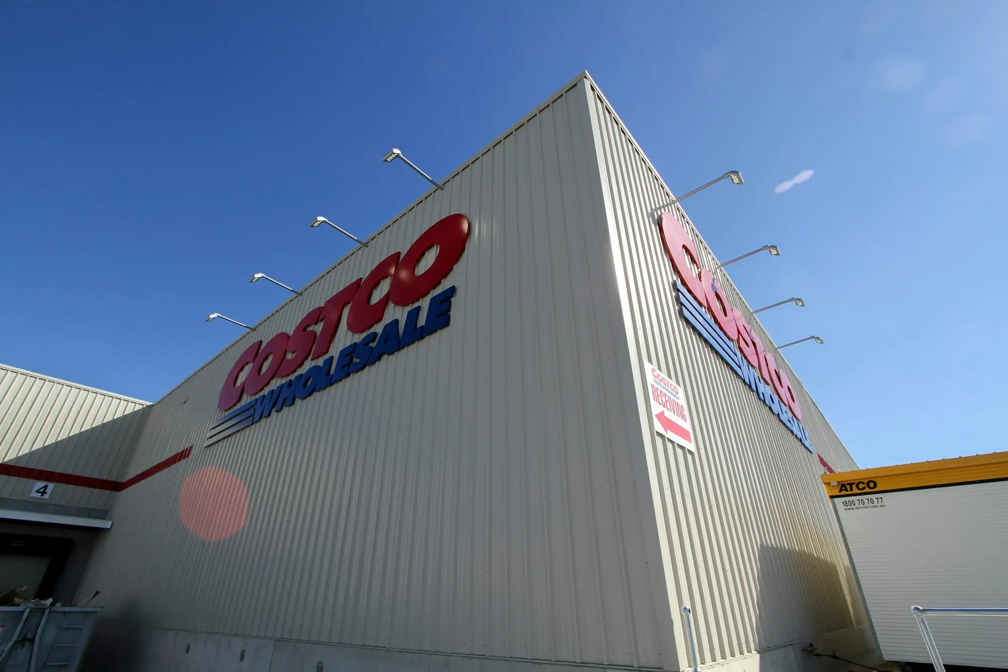 Large white commercial building with signage on the facade