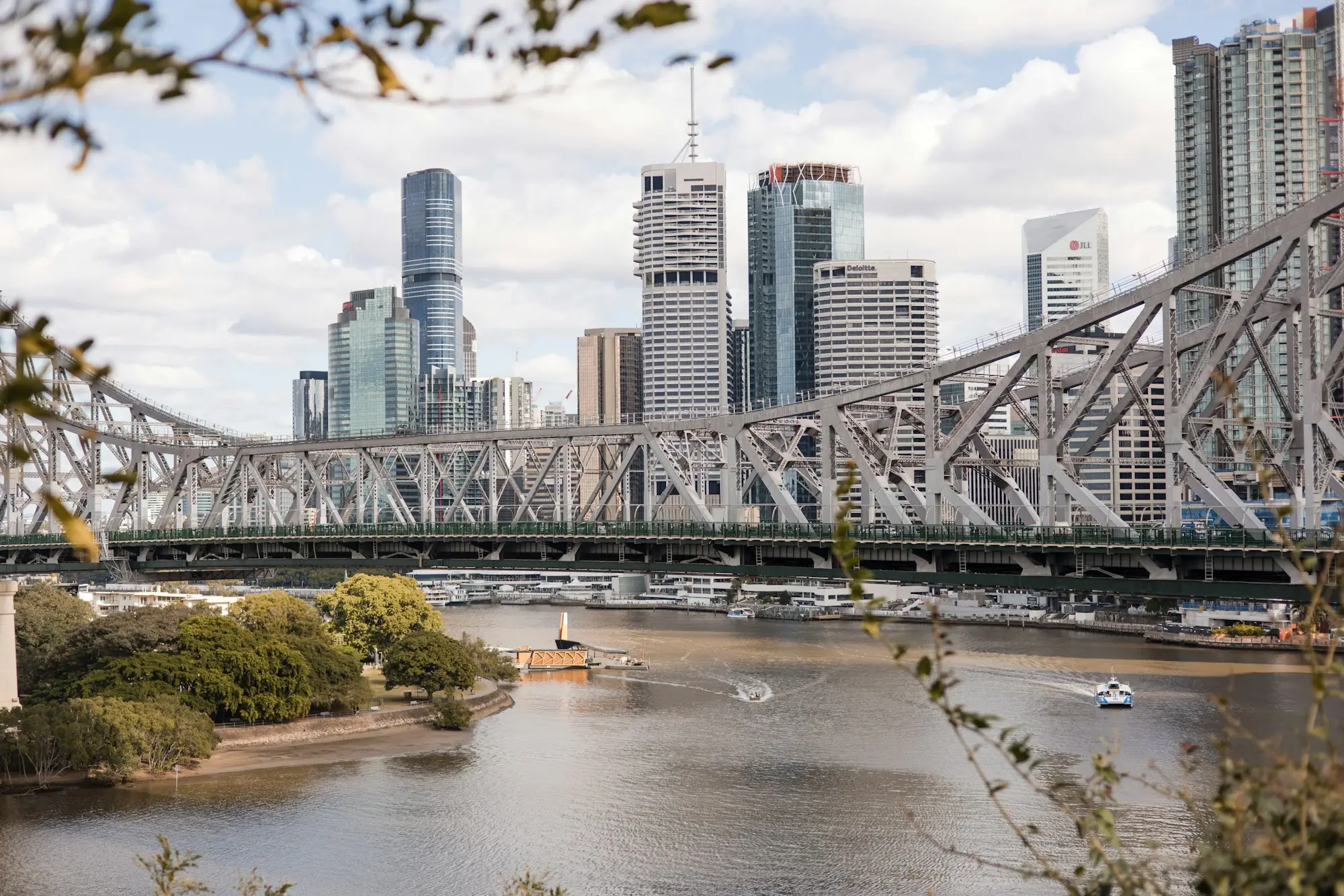 View along the Brisbane River to the bridge and city skyline